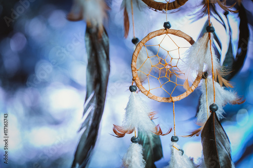 Dreamcatcher against a white blur of snow