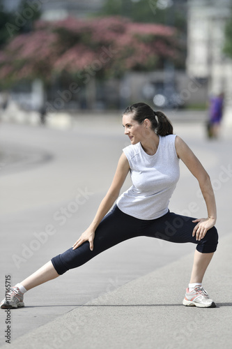 Fitness girl stretching after running