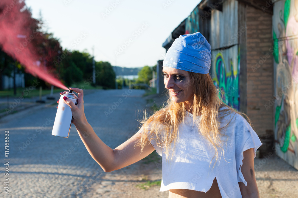 young woman spray paint artist
