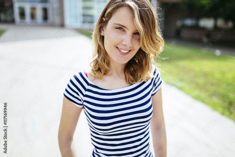 Portrait of relaxed young woman wearing striped t-shirt