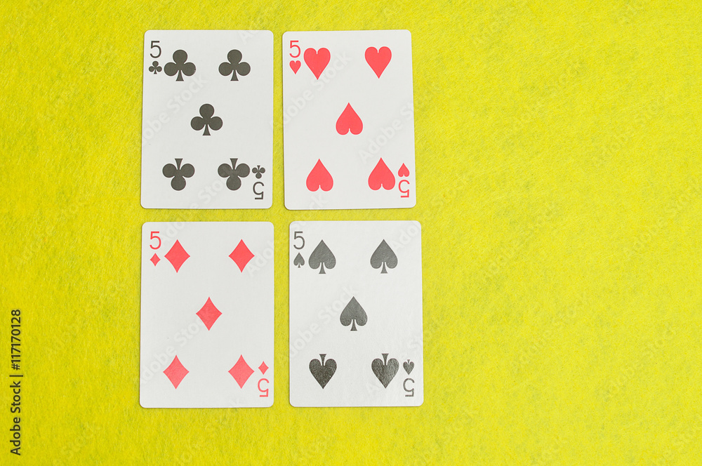 The different suit of the number 5 cards in a deck of cards displayed on a yellow background