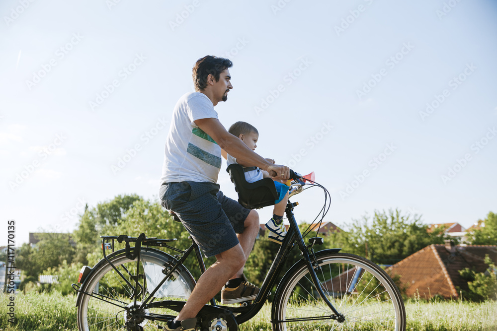 Little boy on bicycle tour with his father Little boy on bicycle tour with his father
