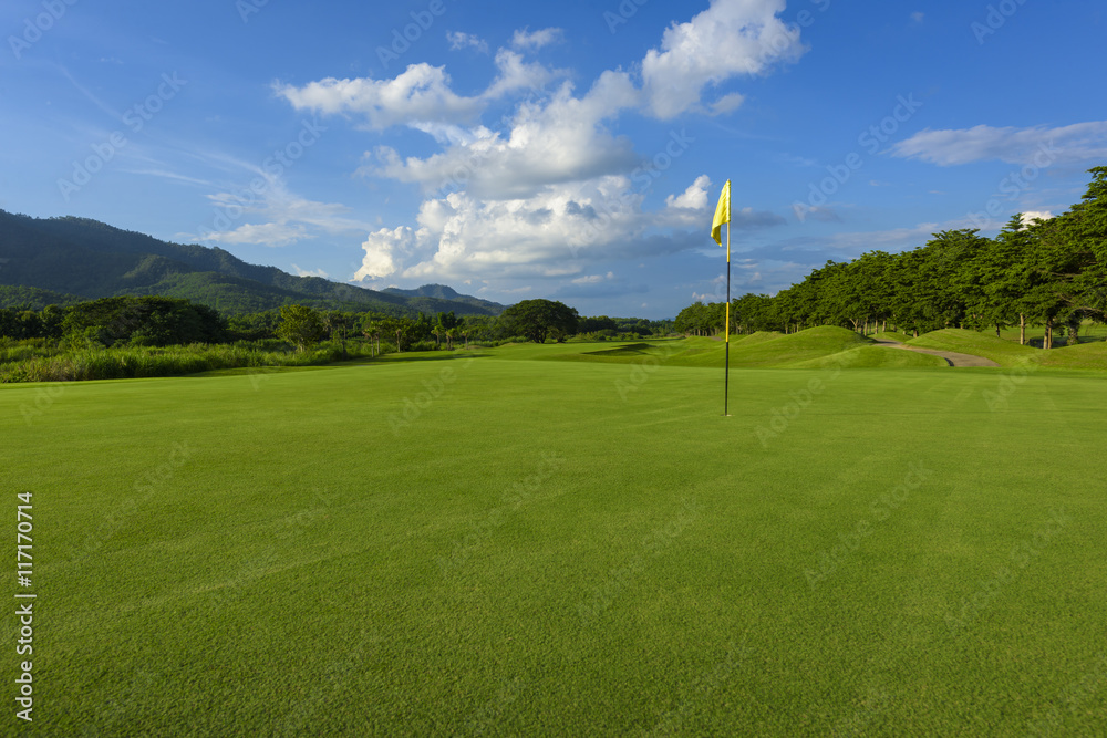 golf course and yellow flag,green fields and blue sky
