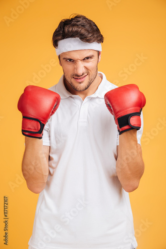 Portrait of strong young man boxer in red gloves © Drobot Dean