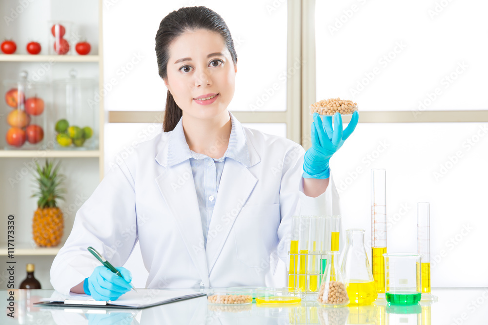 scientist Recording genetic modification data from examining scientist Recording genetic modification data from examining