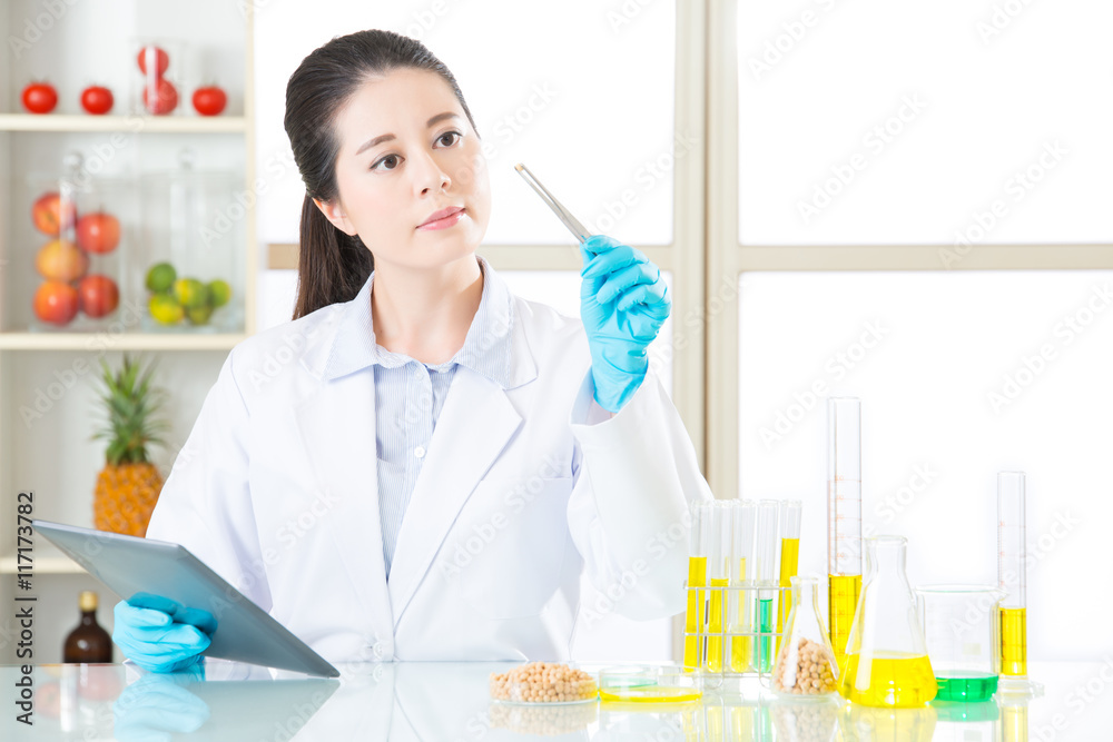 Asian female scientist touch the digital tablet to research for Asian female scientist touch the digital tablet to research for