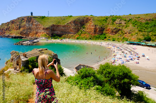 Blonde woman taking pictures at Bolata bay, Bulgaria, Black Sea. photo