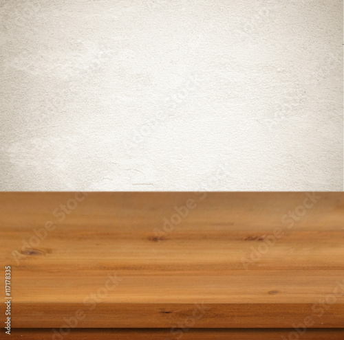 Empty wooden table over vintage cement wall background