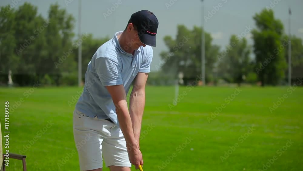 The man play a golf at the course The man play a golf at the course