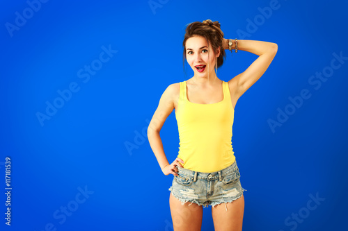 Happy Hipster Fashion Girl on Blue Background