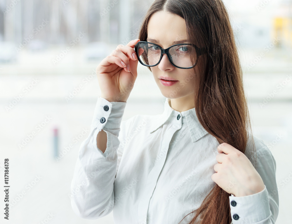 Confident business woman holding glasses