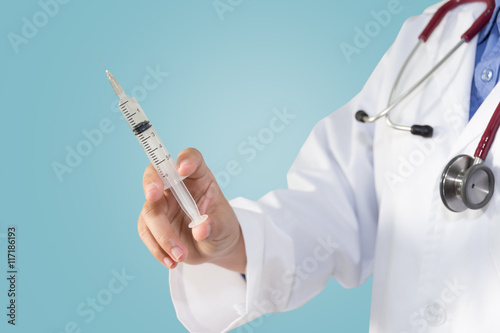 Bild auf Leinwand Female doctor or physician holding hypodermic syringe