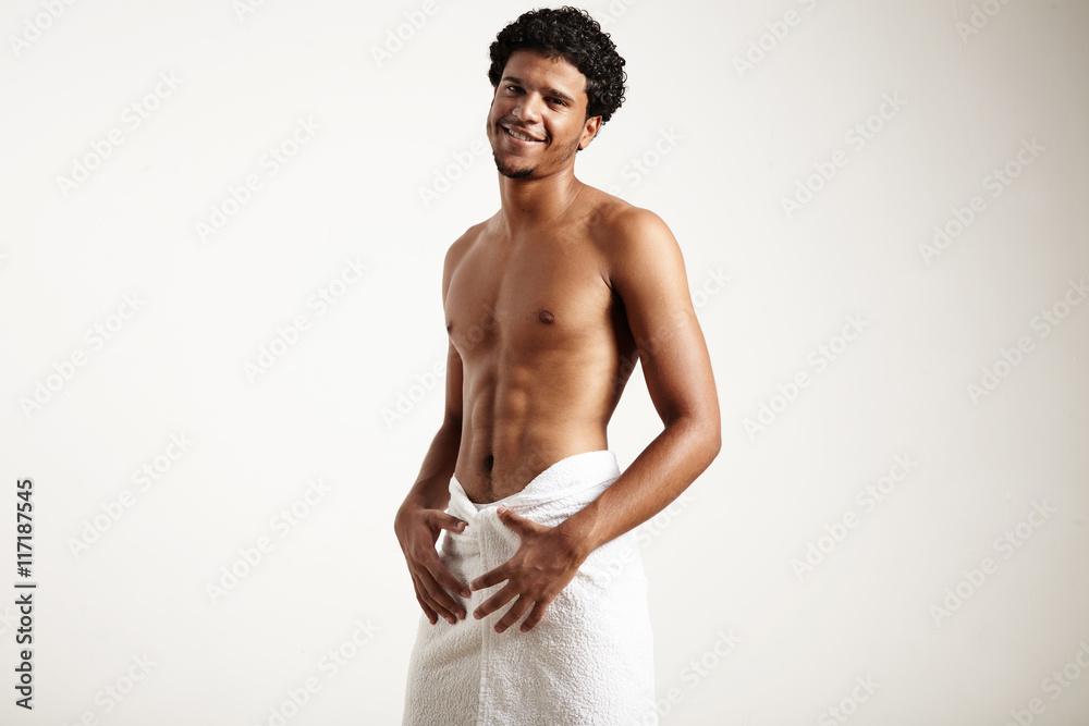Fototapeta premium smiling man after shower wears white towel