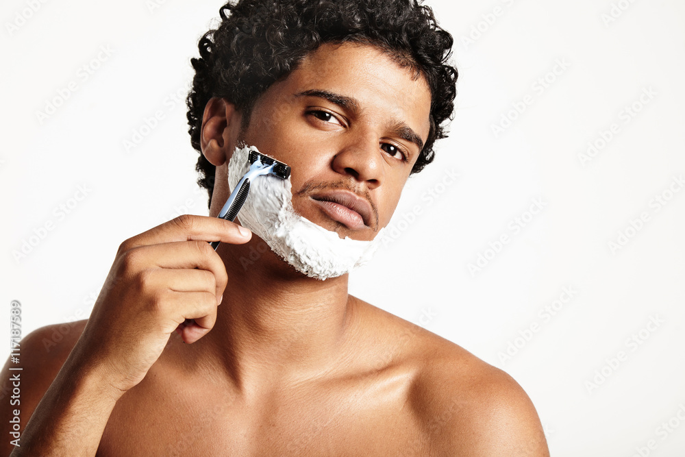 serious young shaving man