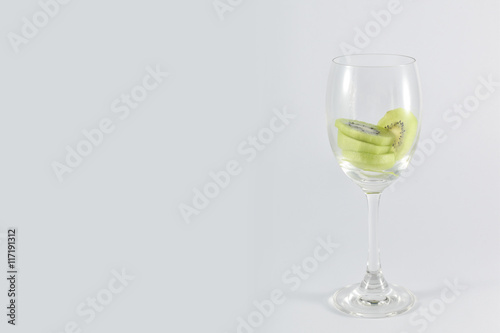 kiwi fruit in a glass wine isolated on white background.