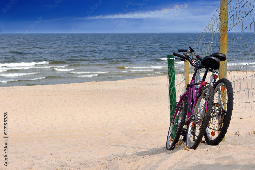 Two bicycles on an empty beach