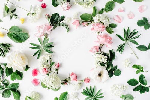 flat lay frame with pink and white roses  branches  leaves and petals isolated on white background. top view