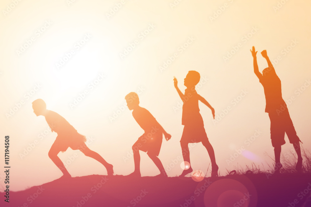 Fototapeta premium silhouette of a happy children and happy time sunset