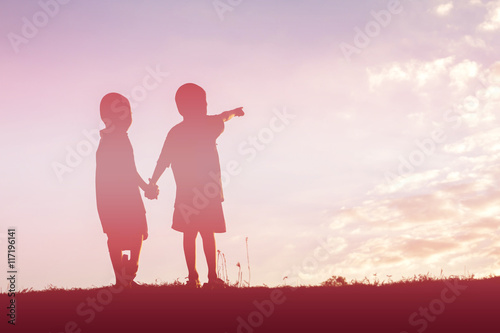 silhouette of a happy children and happy time sunset