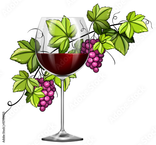 Red wine in glass and grapes in background