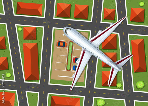 Aerial view of airplane flying over neighborhood