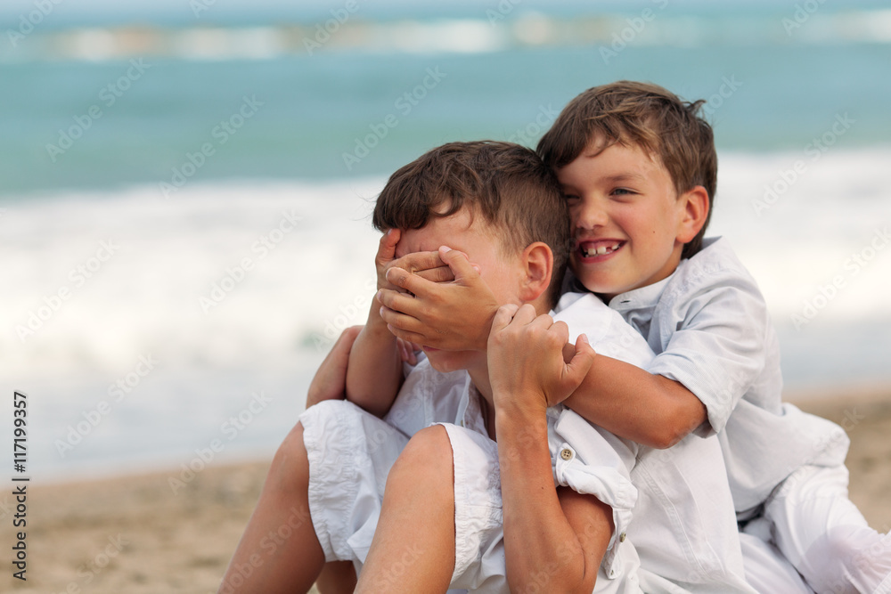 Portrait of happy brothers in white shirts on background of sea Portrait of happy brothers in white shirts on background of sea