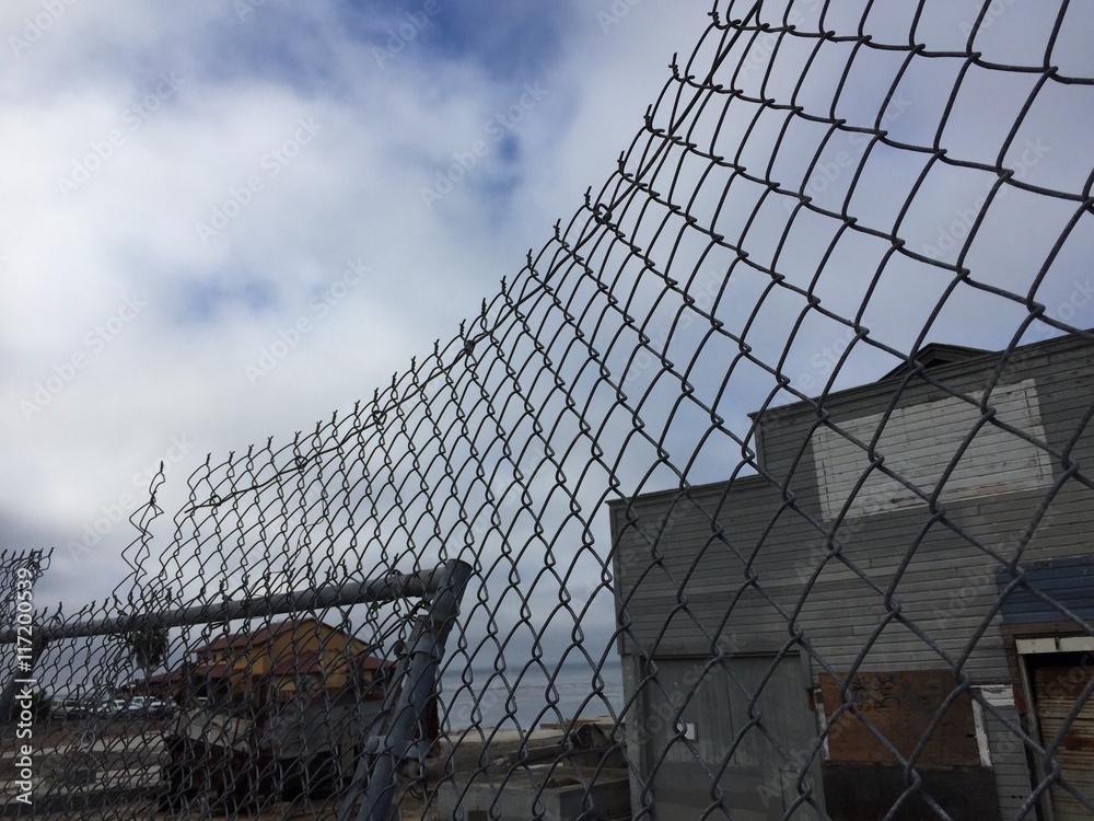 dilapidated building and chain link fence dilapidated building and chain link fence