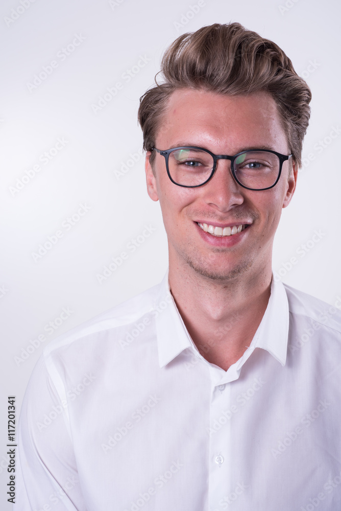 Portrait of a young smiling business man in white shirt