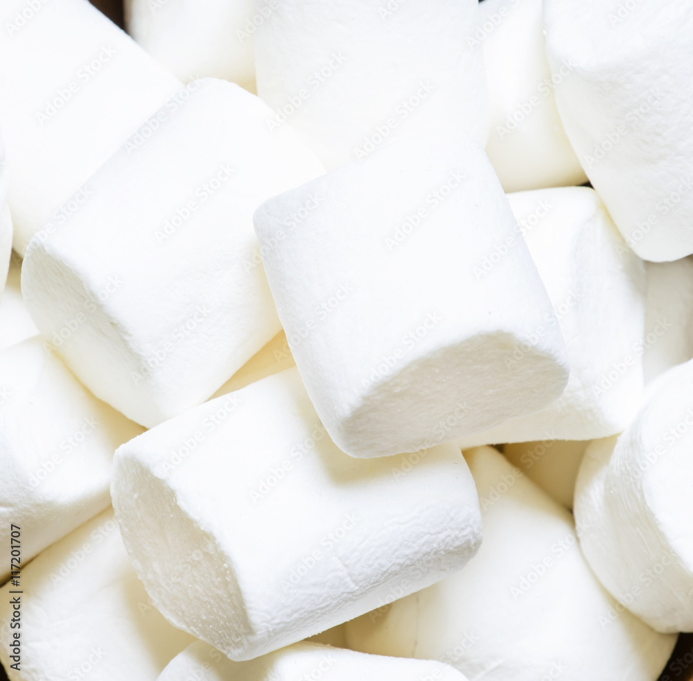 Fotografie Large marshmallow in bowl, wooden background, top view