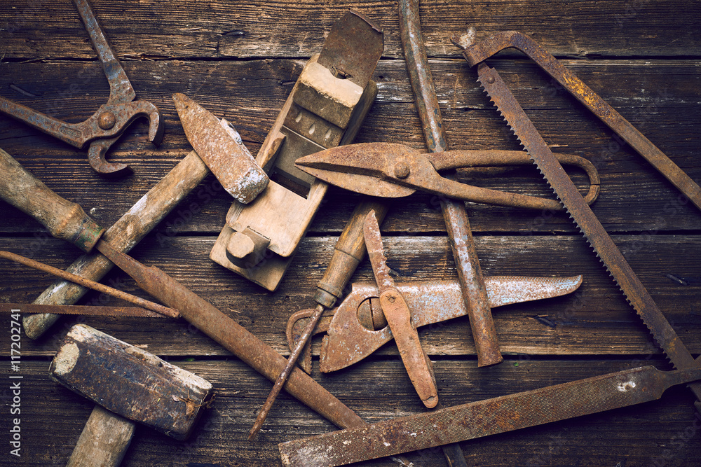 Grungy old rusted tools on a wooden background (processing cross-process) Grungy old rusted tools on a wooden background (processing cross-process)