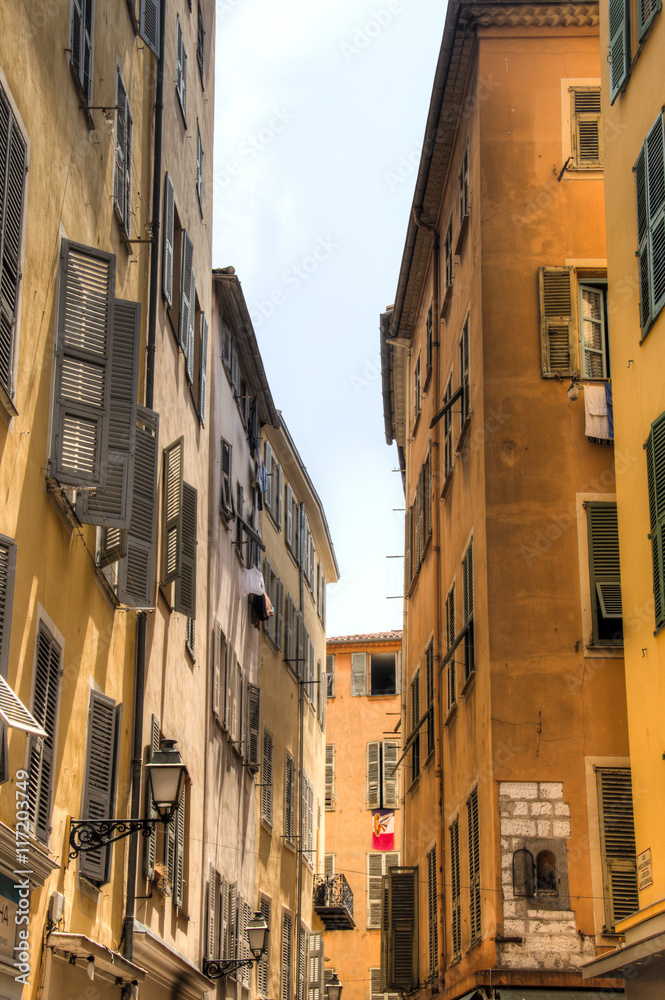 Facades of houses in a small street in Nice on the French Riviera
