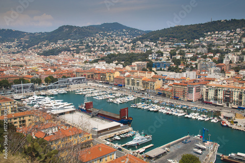 The harbor of Nice in France with some boats, seen from above from behind the cactus trees   © waldorf27