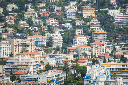 Houses in the harbor of Nice in France with some boats, seen from above from behind the cactus trees   © waldorf27