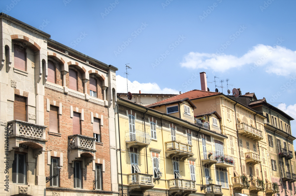 Facade of houses at the main street in the small mountain village Acqui Terme in the north of Italy
