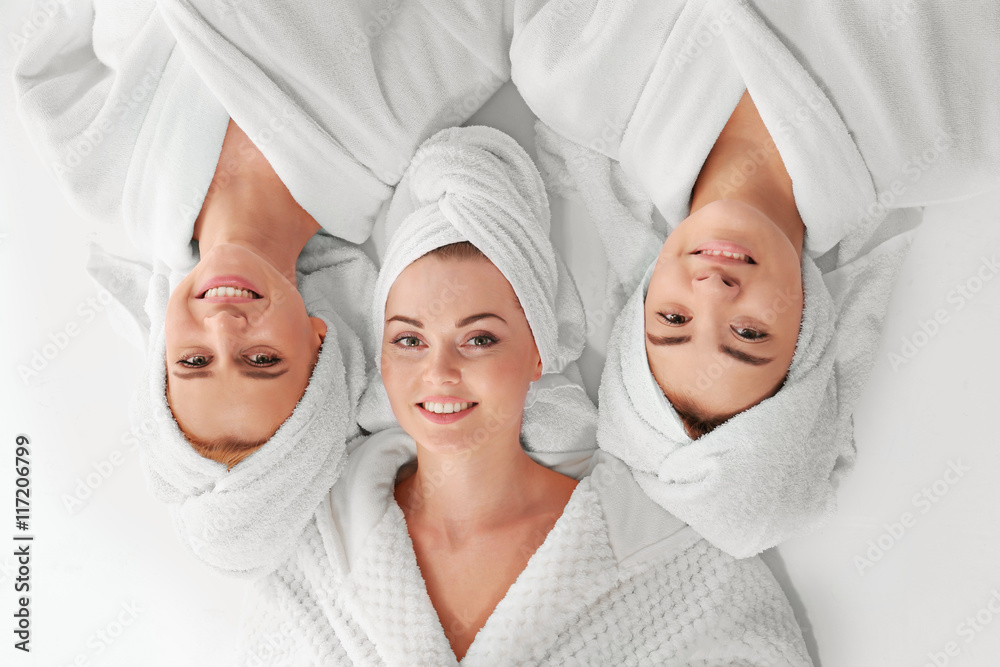 Three beautiful women in dressing gowns, top view Three beautiful women in dressing gowns, top view