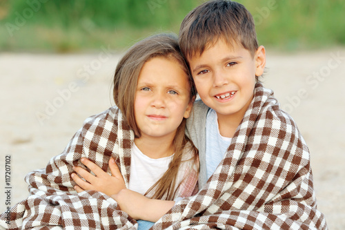 Two cute kids relaxing on beach