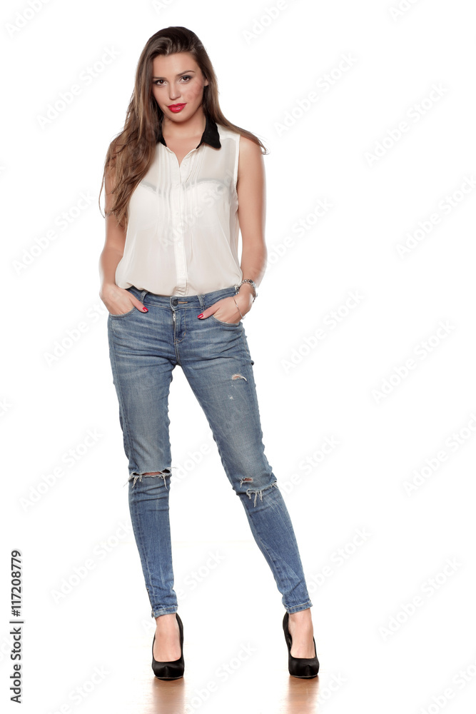 beautiful young woman in jeans and a shirt on a white background beautiful young woman in jeans and a shirt on a white background