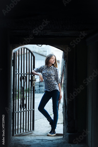 Young girl near forged door