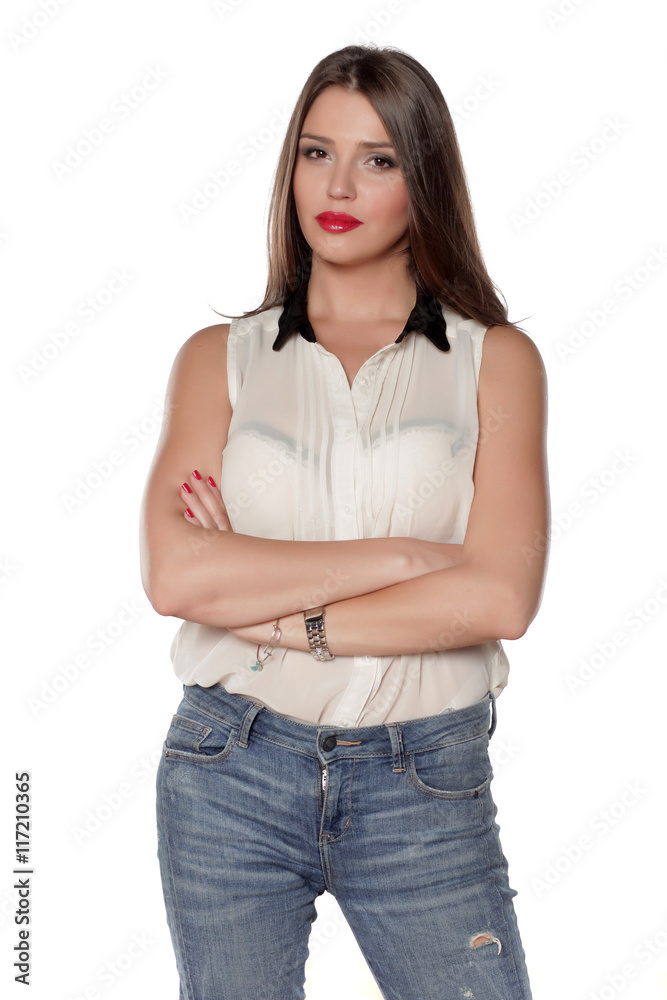 beautiful young woman in jeans and a shirt with crossed hands beautiful young woman in jeans and a shirt with crossed hands