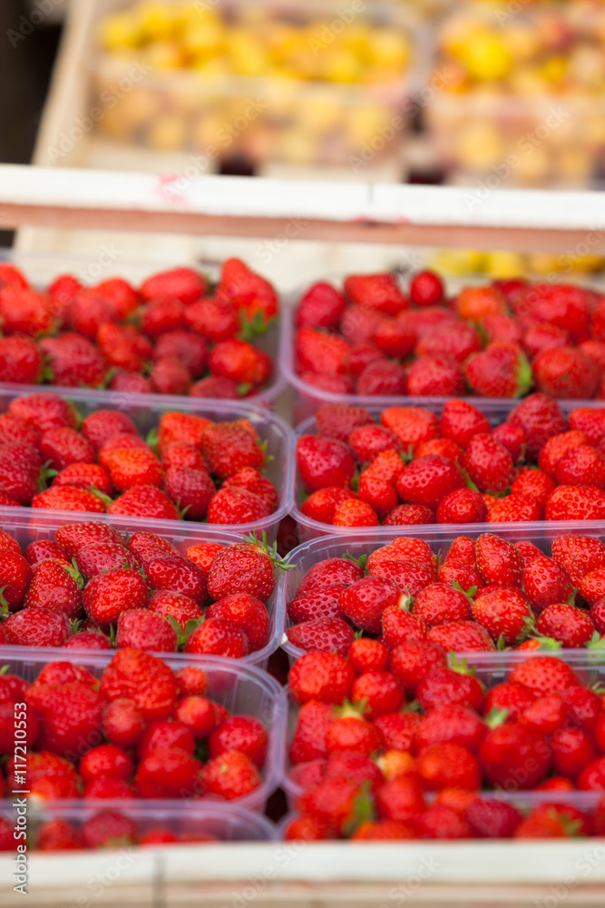 Natural strawberries in boxes at a farmers market Natural strawberries in boxes at a farmers market