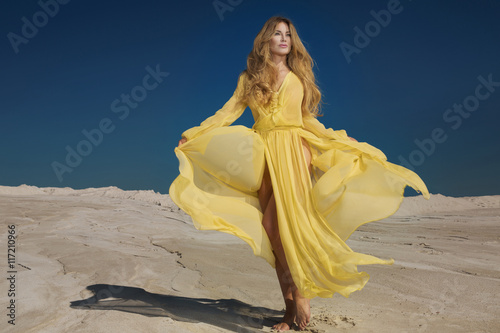 Blonde beautiful lady in yellow dress.