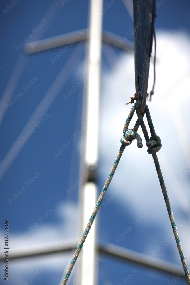Marine cordage on background of mast and blue sky