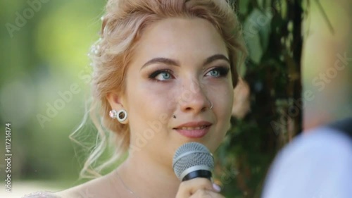 Beautiful blonde bride with nose ring taking vows at wedding ceremony