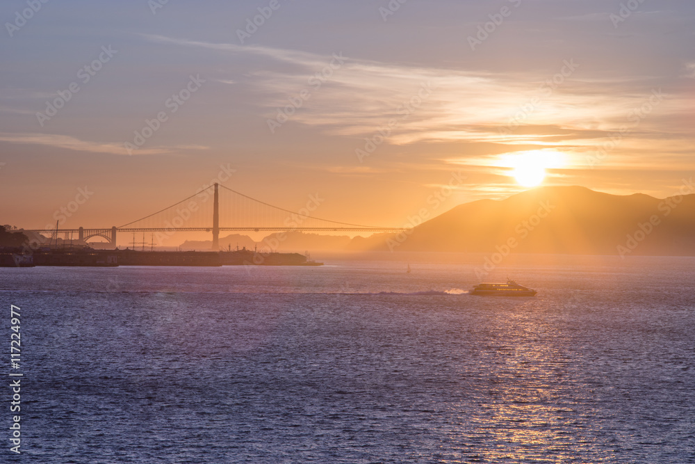 Tourist cruise sails in San Francisco Bay at Sunset