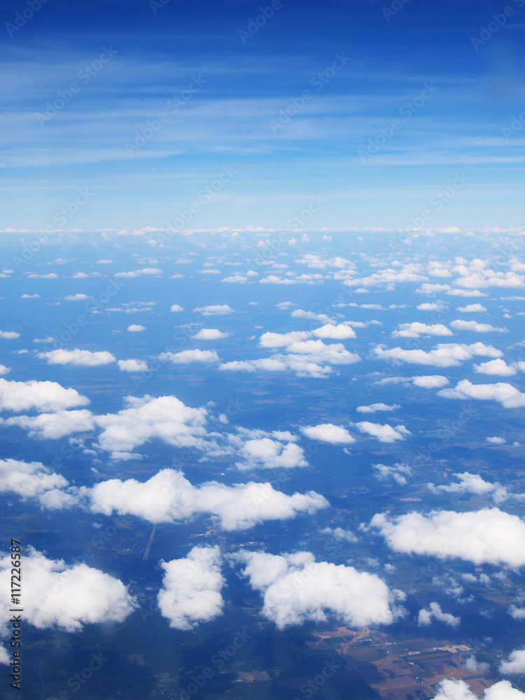 Fototapeta premium View from sky / Seeing land and pieces of white cloud from sky