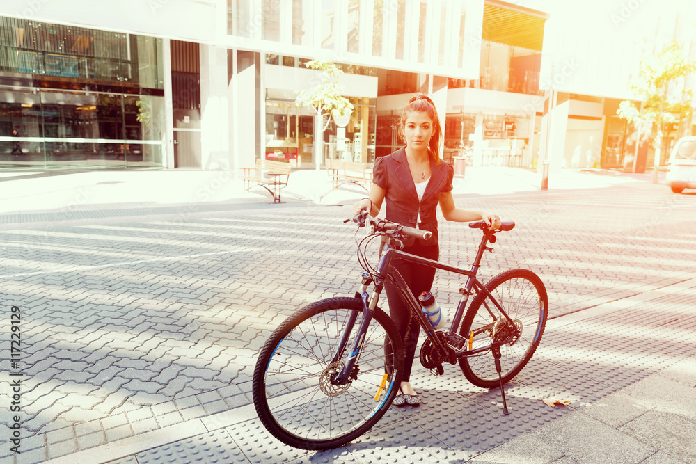 Young woman commuting on bicycle Young woman commuting on bicycle