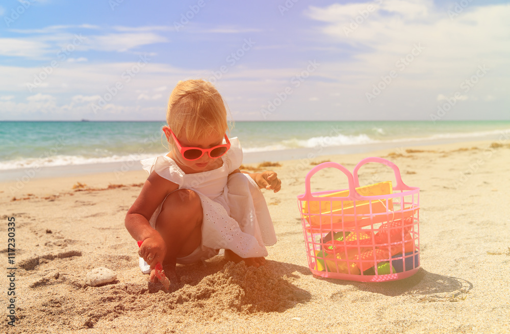 little girl play with sand on beach little girl play with sand on beach