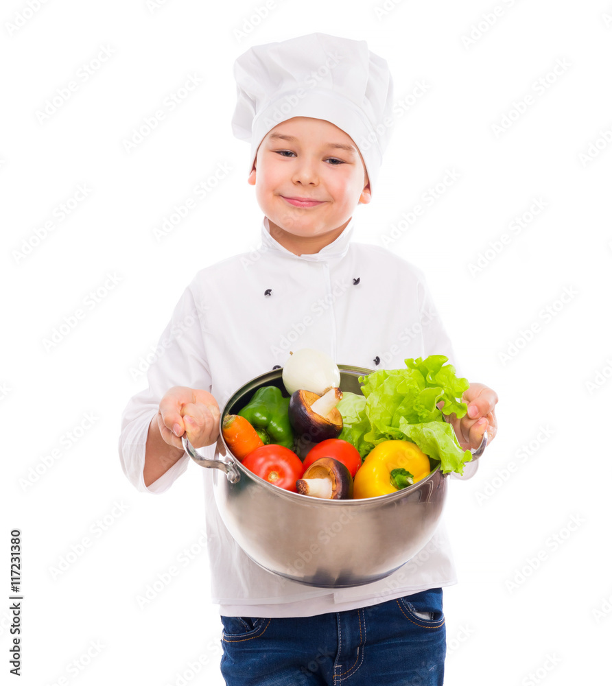 funny little boy-cook in uniform holding bowl with vegetables in hands isollated on white background funny little boy-cook in uniform holding bowl with vegetables in hands isollated on white background