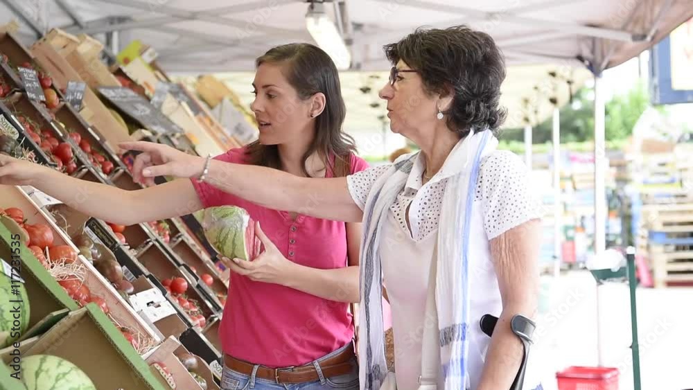 Senior woman going to grocery store with help of carer
