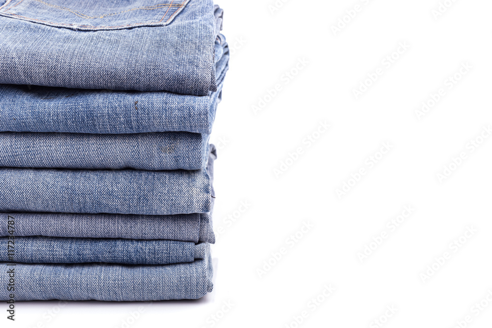 Stack of old blue jeans isolated on white Stack of old blue jeans isolated on white
